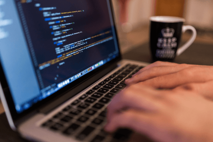 Worker programming a website on a laptop